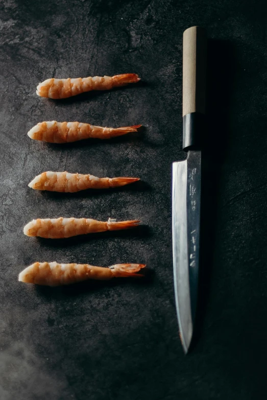 a bunch of shrimp next to a knife on a table, a digital rendering, inspired by Kanō Shōsenin, unsplash, hurufiyya, five fingers, thumbnail, 5 years old, made of glazed