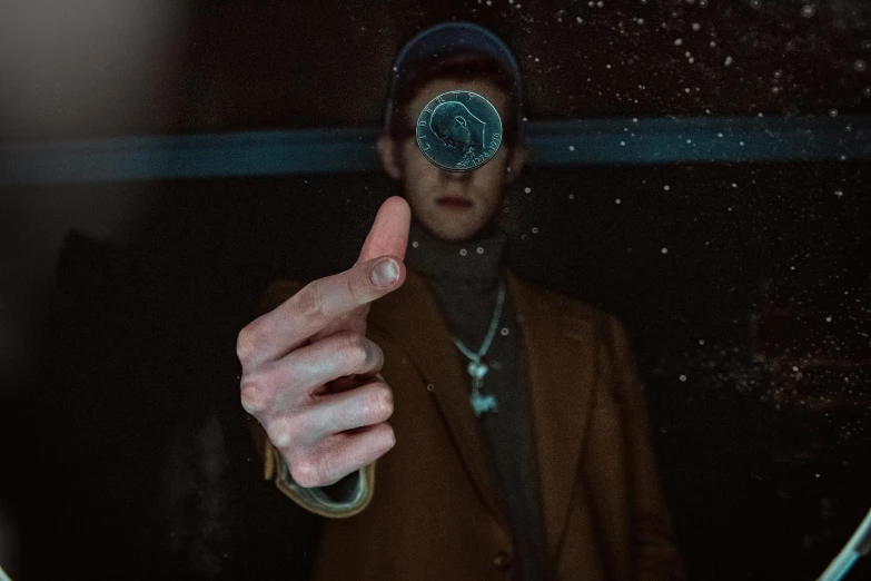 a man that is standing in front of a mirror, an album cover, trending on pexels, magical realism, point finger with ring on it, wearing a patch over one eye, shot from below, connor hibbs