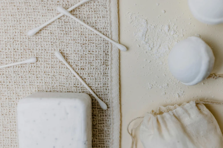 a bunch of items sitting on top of a table, by Helen Stevenson, trending on pexels, process art, cotton texture, soap, white mechanical details, product design shot