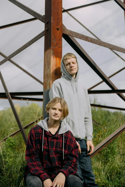 a couple of people that are sitting in the grass, an album cover, by Attila Meszlenyi, unsplash, renaissance, teenage boy, nordic, 15081959 21121991 01012000 4k, looking straight