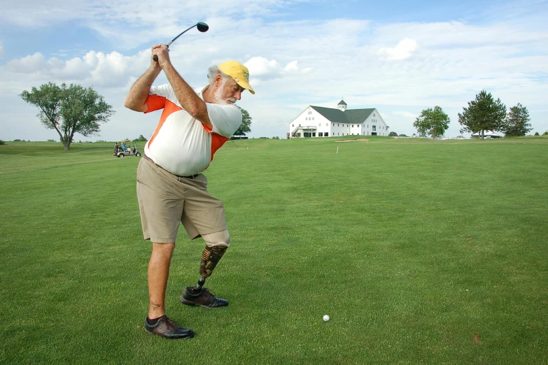 a man swinging a golf club at a golf course, a photo, by Ben Zoeller, hide the pain harold, prosthetic leg, wikimedia, wearing a tee shirt and combats