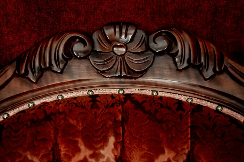 a close up of a chair with a red background, a portrait, trending on zbrush central, art nouveau, vintage - w 1 0 2 4, velvet couch, professional woodcarving, arched back