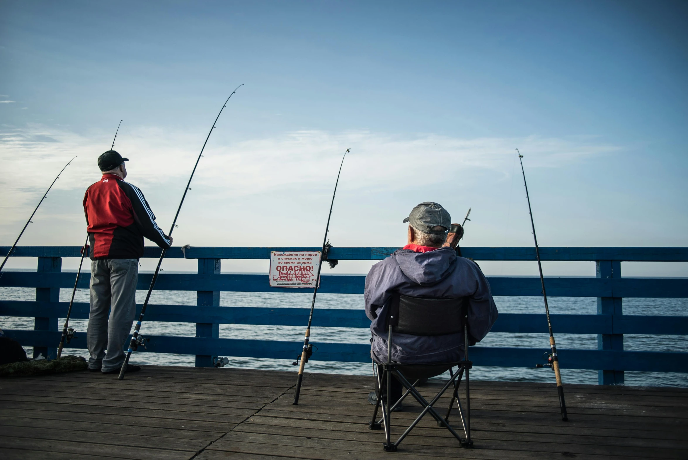 a couple of people that are sitting in chairs, unsplash, realism, fishing pole, high resolution photo, southern california, peter hurley