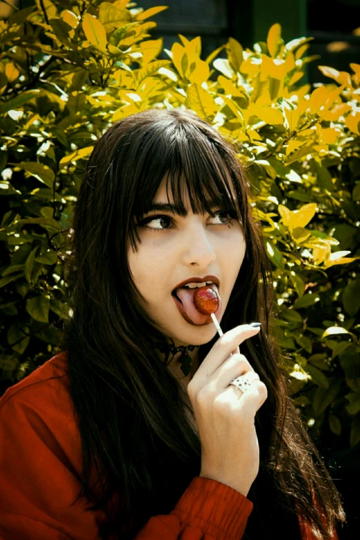 a woman brushing her teeth in front of a bush, an album cover, inspired by Elsa Bleda, unsplash, pop art, long dark hair with bangs, fight with strawberries, ana de armas portrait, hot dog