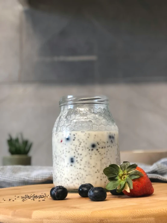 a jar of yogurt sitting on top of a wooden cutting board, a picture, reddit, hurufiyya, berries dripping juice, singapore, avatar image, starry