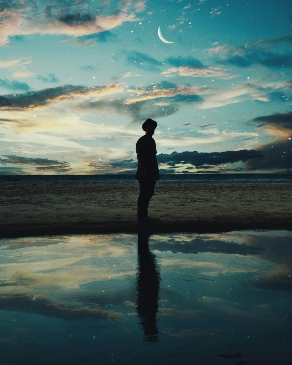 a person standing on a beach next to a body of water, an album cover, unsplash contest winner, magical realism, ☁🌪🌙👩🏾, night mood, beautiful boy, marvellous reflection of the sky
