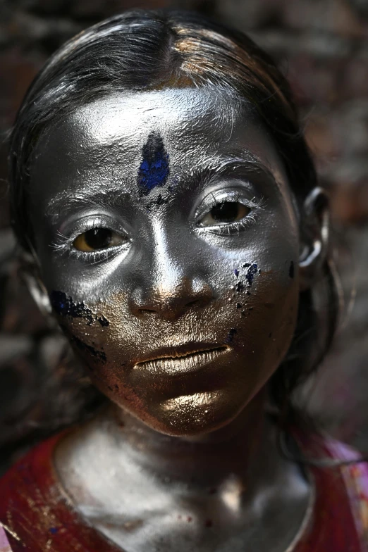 a woman with silver paint on her face, an album cover, inspired by Steve McCurry, pexels contest winner, bengal school of art, metallic colors, kids, innocent face, teenage girl