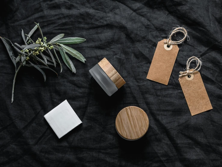 various items laid out on a black cloth, inspired by Eden Box, trending on pexels, wood ornaments, skincare, grey, thumbnail