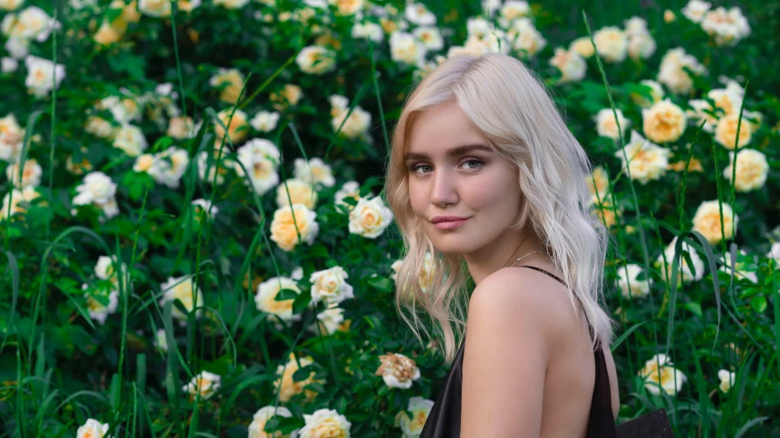 a woman standing in a field of yellow flowers, an album cover, inspired by Elsa Bleda, pexels contest winner, photorealism, perfect white haired girl, sitting in the rose garden, lily collins, blonde crea