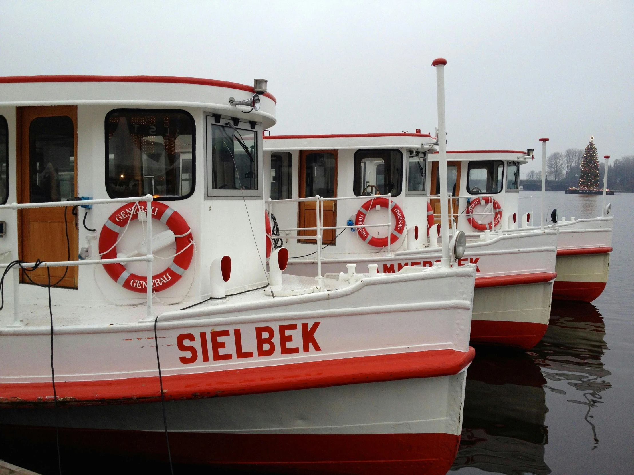 a couple of boats that are sitting in the water, red and white, berkerk, with names, exterior photo