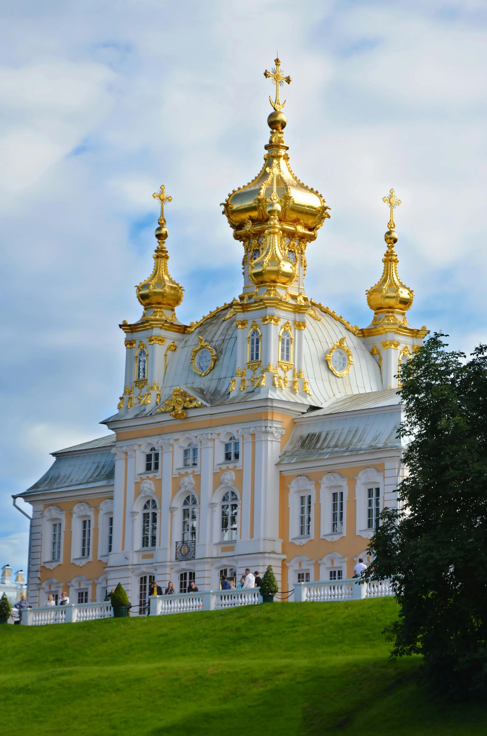 a large building sitting on top of a lush green hillside, inspired by Illarion Pryanishnikov, rococo, beautiful gold saint, viewed from the harbor, up-close, square