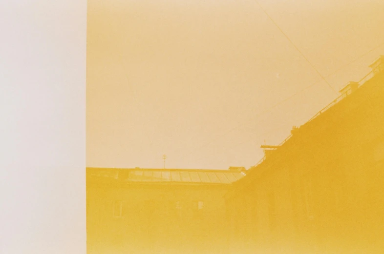 a red fire hydrant sitting in front of a tall building, a polaroid photo, inspired by Zhang Kechun, postminimalism, gradient yellow, light breaks through the roofs, duotone screen print, yellow-orange