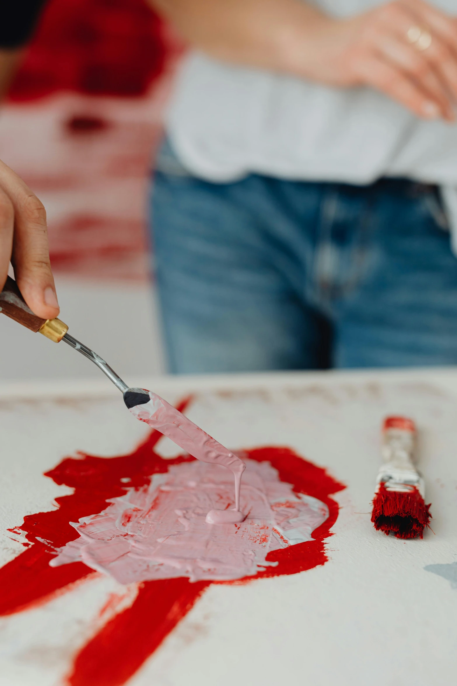 a person using a paintbrush to paint a piece of paper, inspired by Helen Frankenthaler, trending on pexels, action painting, red and white color scheme, portrait made of paint, oil paint impasto reliefs, blueprint red ink