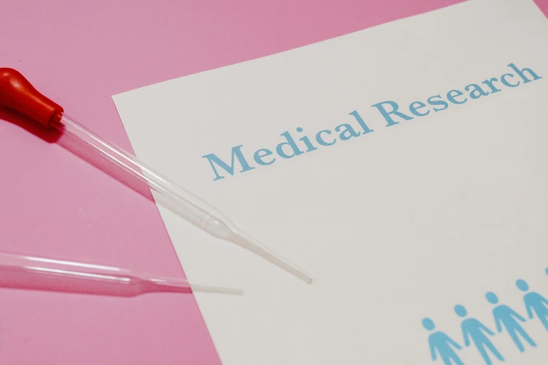 a medical research paper sitting on top of a pink table, by Rachel Reckitt, trending on reddit, holding a syringe, graphic design | meta design, resin, plain background