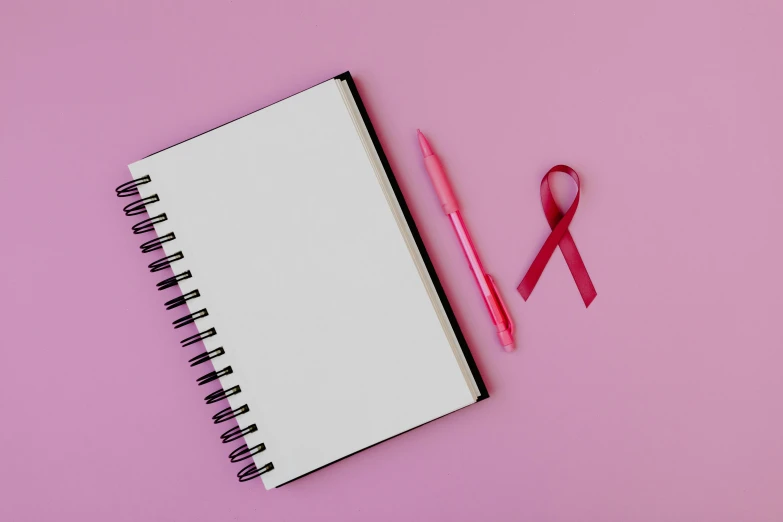 a notebook with a pink ribbon next to it, pexels, happening, full body image, instagram post, red ribbon, no - text no - logo