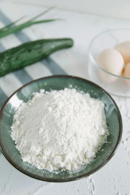 a bowl of flour next to a bowl of eggs, a still life, unsplash, cucumbers, square, made of glazed, powder