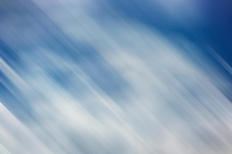 a blurry photo of a plane flying in the sky, inspired by Cleve Gray, unsplash, lyrical abstraction, blue metal, diagonal strokes, soft organic abstraction, cloud