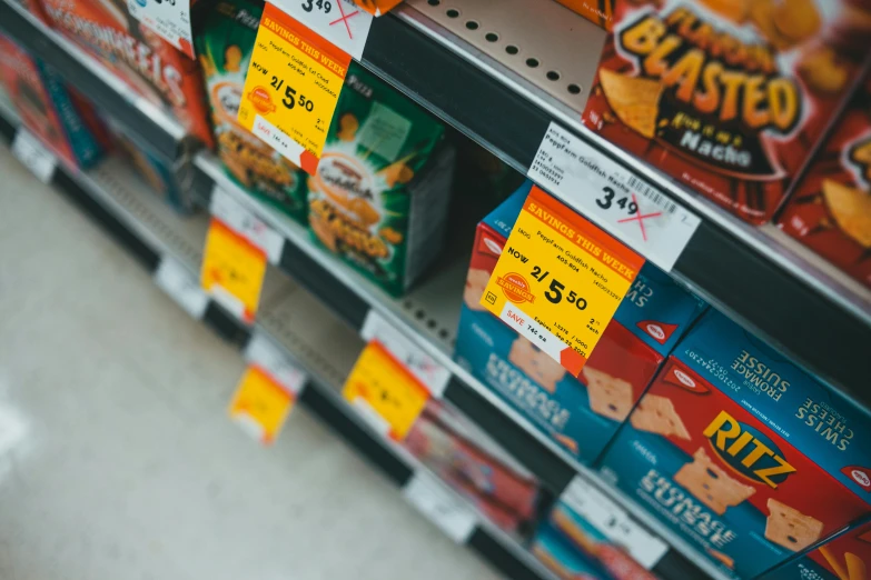 a variety of snacks on a shelf in a store, pexels, hyperrealism, orange safety labels, square, thumbnail, thirst