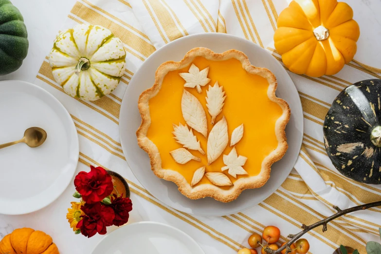 a pie sitting on top of a white plate, a still life, inspired by Elsa Beskow, shutterstock contest winner, glowforge template, colors: yellow, pumpkin, holiday