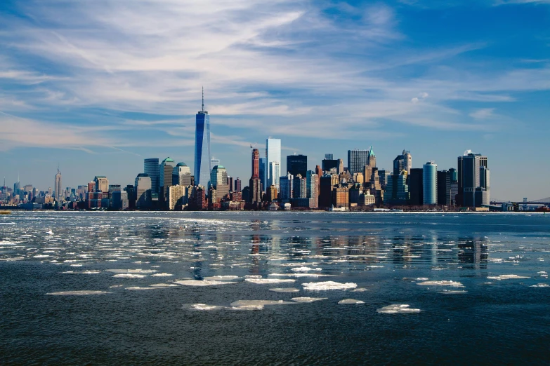 a large body of water with a city in the background, a photo, by Julia Pishtar, pexels contest winner, hudson river school, cold as ice! 🧊, background image, skyline showing, on a bright day