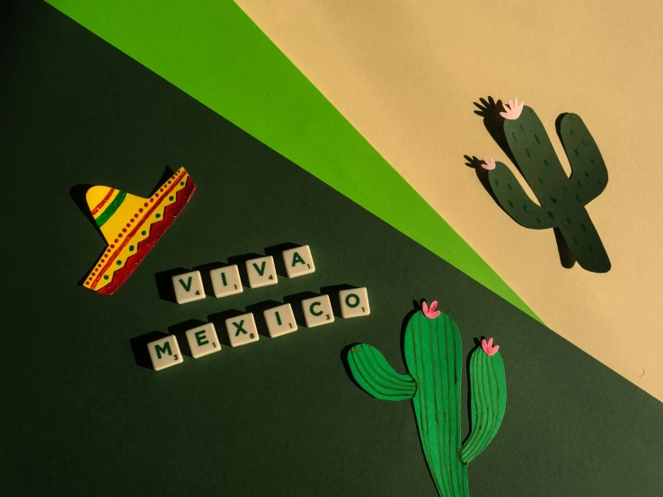 a refrigerator covered in magnets next to a cactus, trending on pexels, folk art, green letters, sombrero, background image, rivuletpaper art