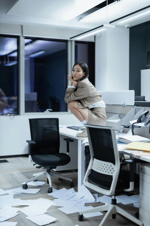 a woman sitting on a chair in an office, by Jang Seung-eop, trending on unsplash, happening, parody work, late night, architect, half turned around