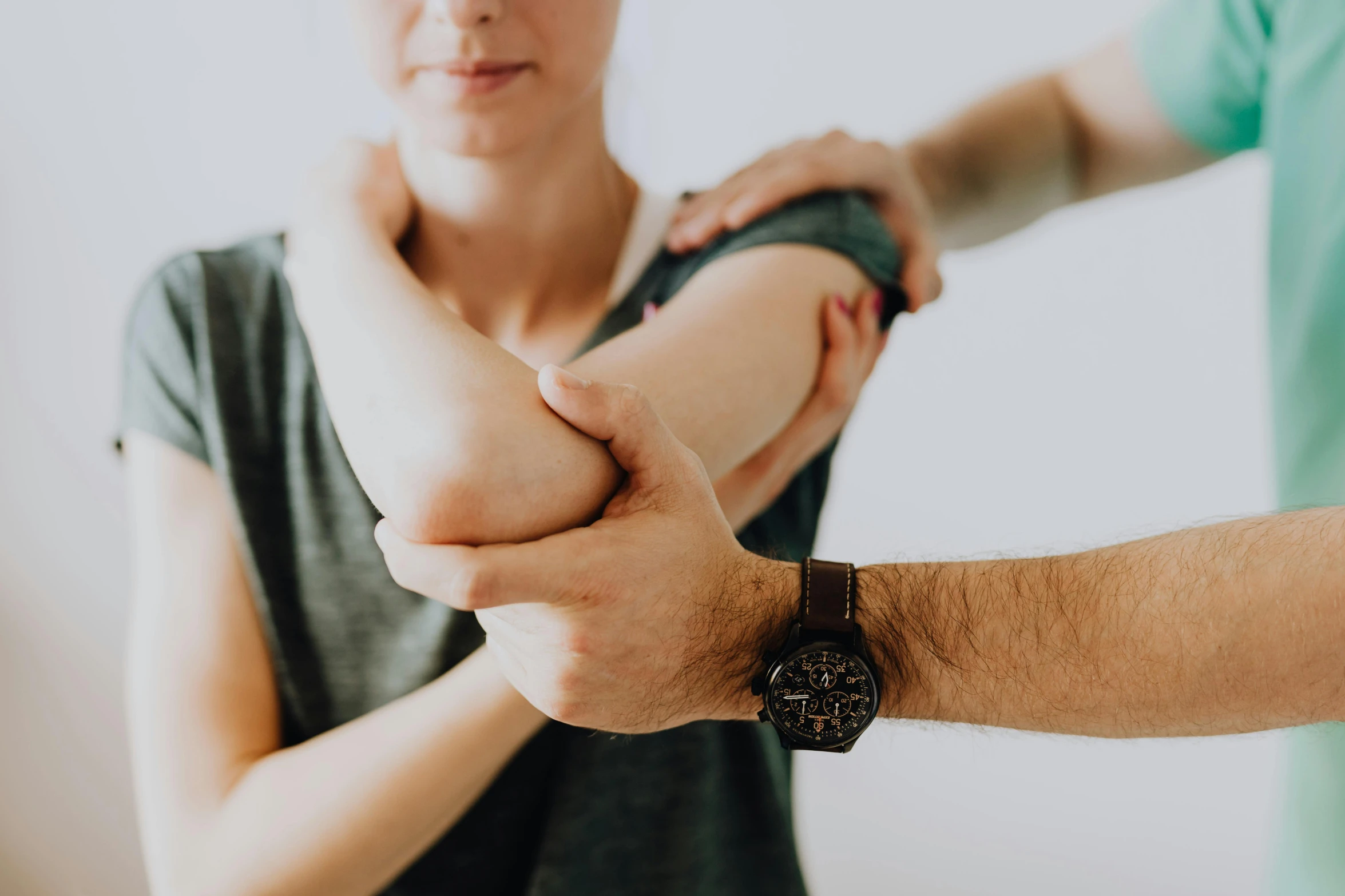 a woman holding the wrist of a man in a green shirt, by Adam Marczyński, pexels contest winner, renaissance, nerves and muscles, background image, elbow, holding a 🛡 and an 🪓