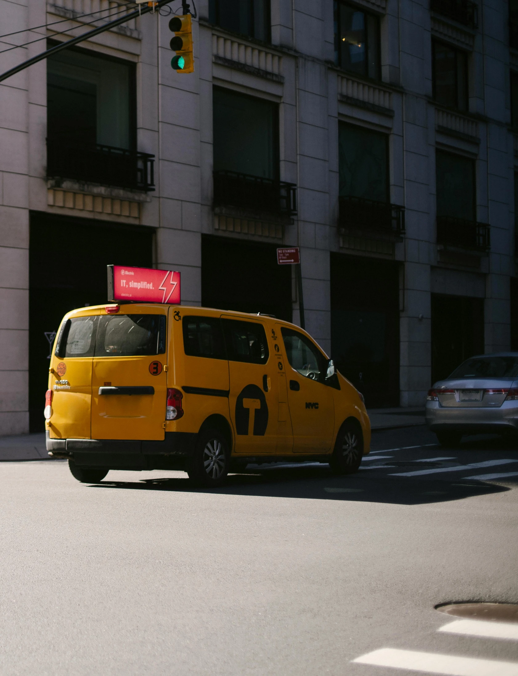 a yellow van driving down a street next to a tall building, thumbnail, high-quality photo, injured, ignant