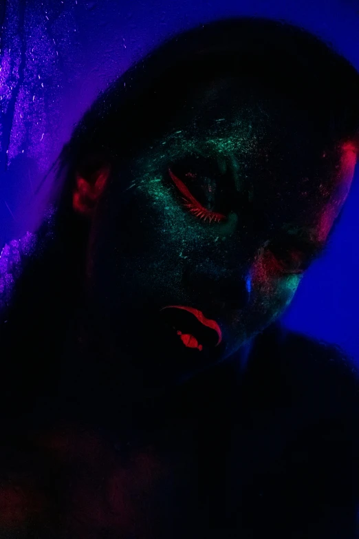 a woman with black light on her face, an album cover, pexels contest winner, blue and green and red tones, !!! colored photography, dark glitter, dark blue skin
