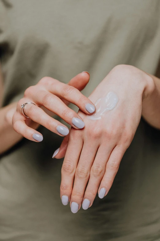 a woman putting cream on her hands, by Adam Marczyński, trending on pexels, renaissance, square, coerent face and body, palm body, ilustration