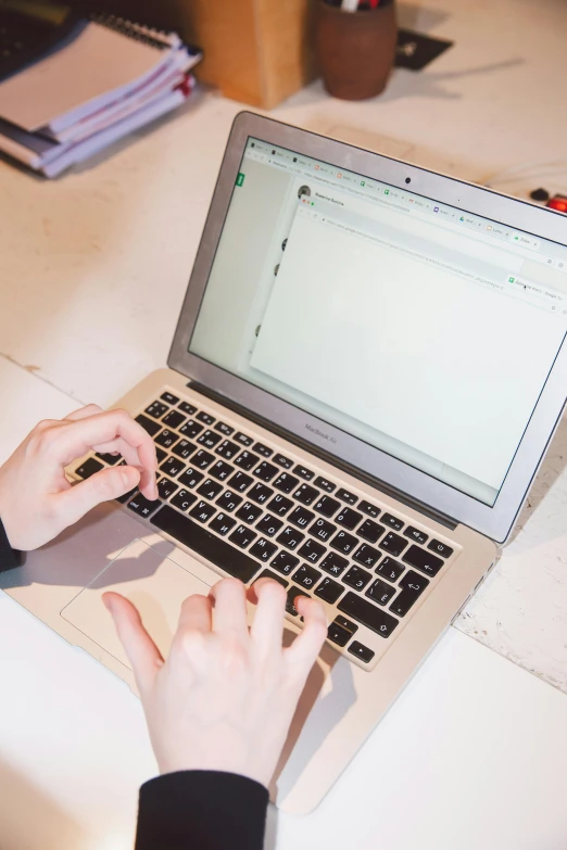 a person typing on a laptop computer on a desk, by Robbie Trevino, trending on unsplash, 2 5 6 x 2 5 6 pixels, jen atkin, on the qt, official screenshot