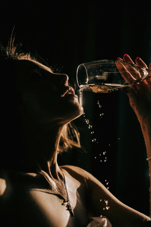 a woman drinking from a wine glass in the dark, inspired by Elsa Bleda, pexels contest winner, renaissance, sweaty and dirty, sparkling water, pouring, 🍸🍋