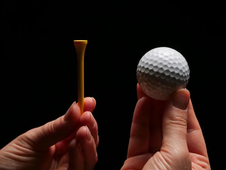 a person holding a golf ball and a golf tee, by Matthias Stom, plasticien, physically accurate, forshortening, medium-shot, precision