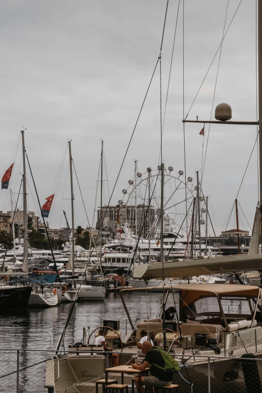 a number of boats in a body of water, by Carlo Martini, pexels contest winner, renaissance, cannes, grey, low quality photo, taken with sony alpha 9