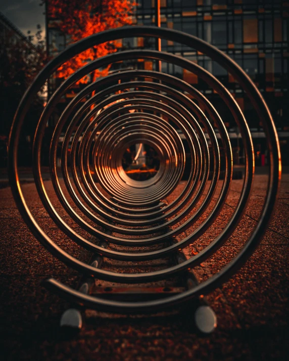 a metal sculpture sitting in the middle of a park, pexels contest winner, tube wave, instagram story, circles, warmly lit