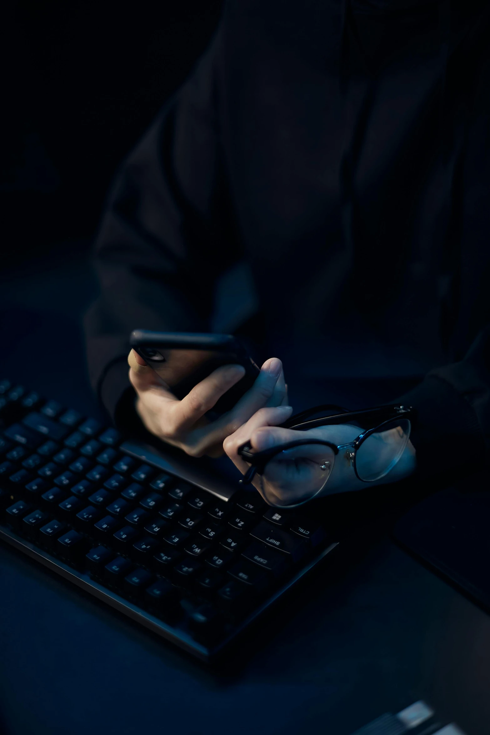 a person holding a cell phone and typing on a keyboard, tech noir, avatar image, multiple stories, navy