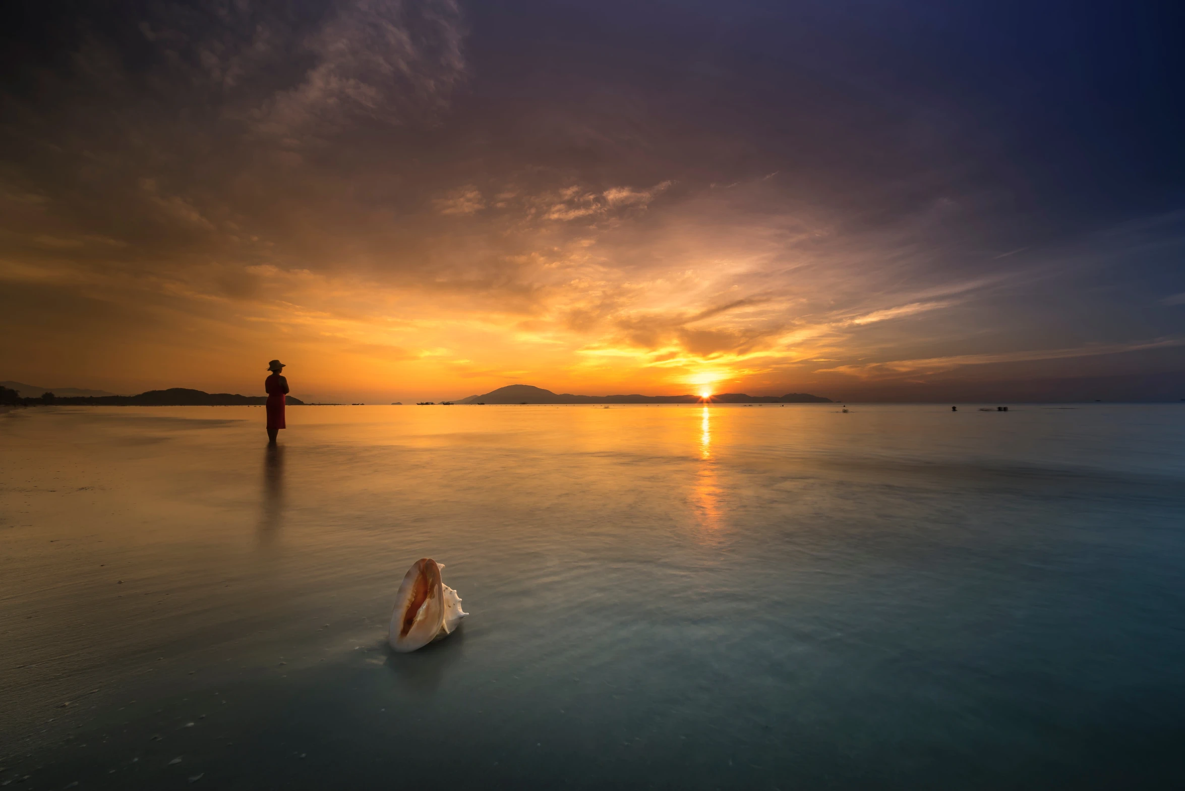 a man standing on top of a beach next to a body of water, by Raymond Han, unsplash contest winner, romanticism, sunset + hdri, in a lake, bao phan, floating in water