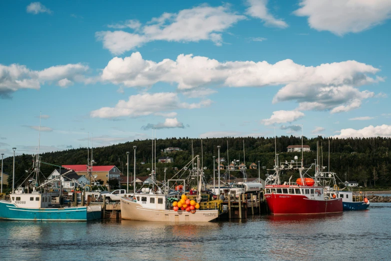 a number of boats in a body of water, by Julia Pishtar, pexels contest winner, plein air, harbour in background, unsplash photo contest winner, craigville, brightly coloured