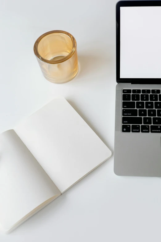 a laptop computer sitting on top of a desk next to a cup of coffee, by Carey Morris, trending on unsplash, white minimalistic background, magical notes, background image, light cream and white colors