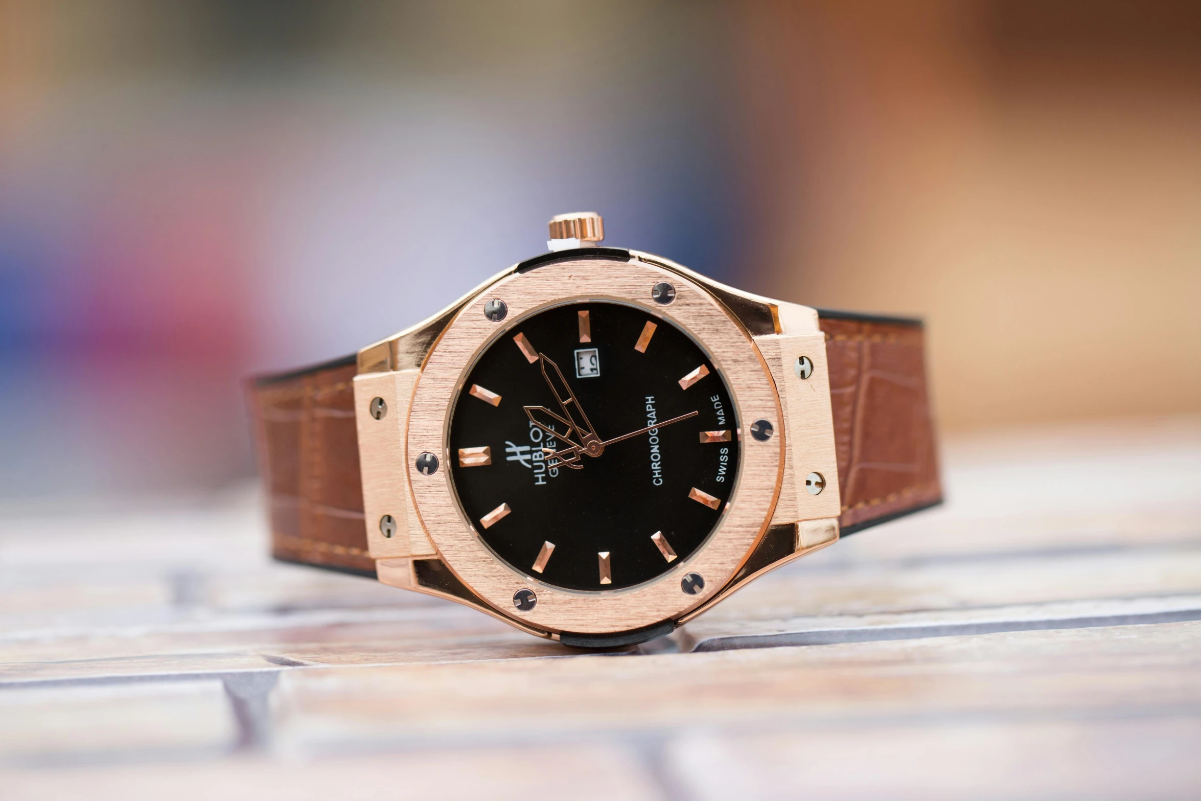 a close up of a watch on a table, a portrait, by Julia Pishtar, unsplash, hublot, brown and gold, exterior shot, on display