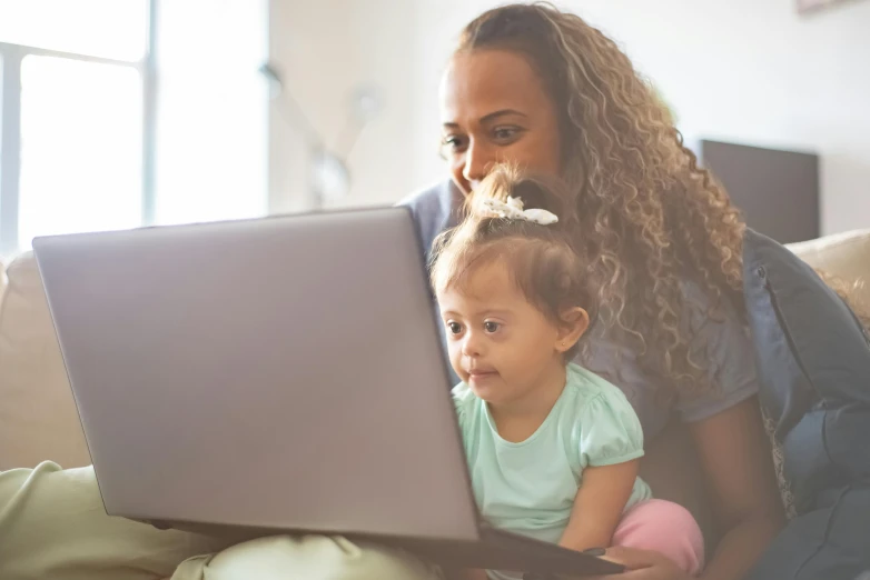 a woman and child sitting on a couch looking at a laptop, pexels, square, avatar image, close up photograph, toddler
