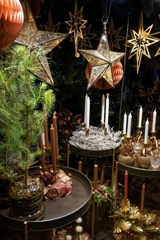 a table topped with lots of candles and christmas decorations, by Jan Tengnagel, copper and brass, large magical trees, lots of stars, swedish