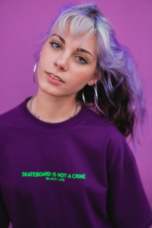 a woman wearing a purple shirt that says skateboarding is not a crime, trending on pexels, 🤤 girl portrait, dasha taran, lil peep, official store photo