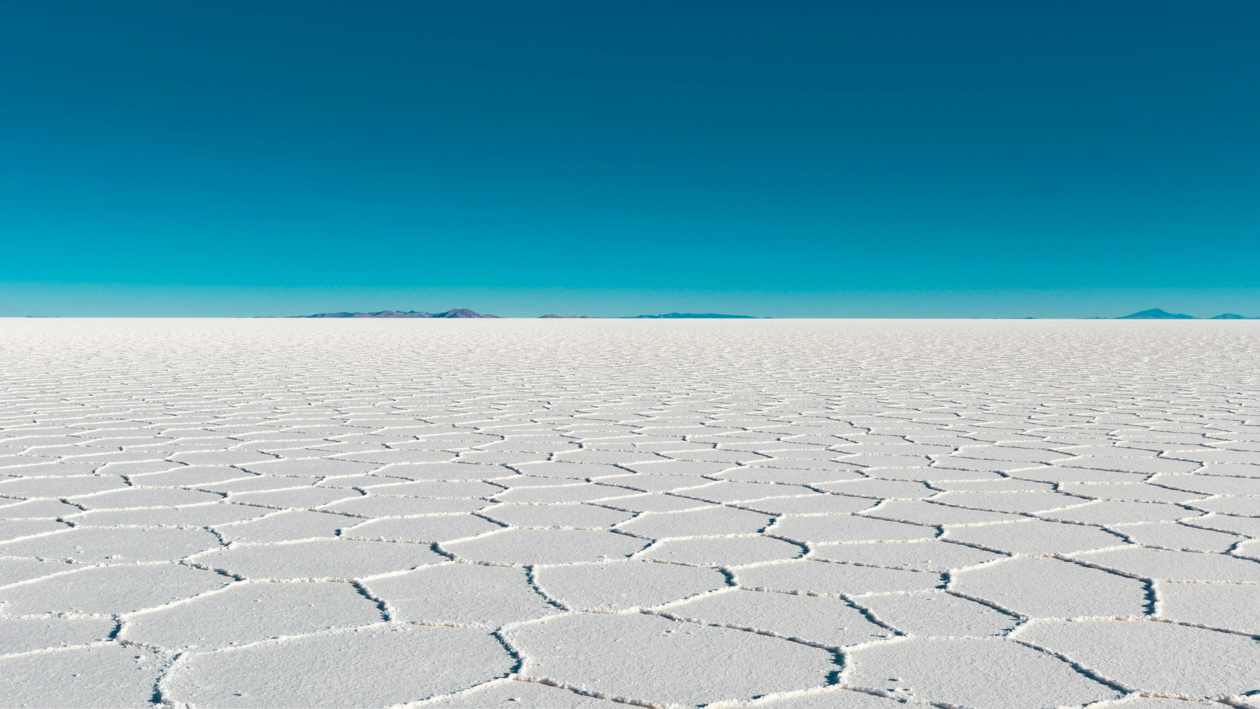 a white desert with a blue sky in the background, inspired by Scarlett Hooft Graafland, unsplash contest winner, land art, crystalized scales, ignant, very sparse detail, wired landscape