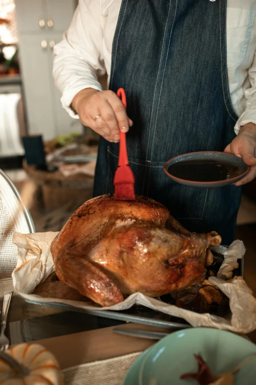 a person preparing a turkey in a kitchen, pexels contest winner, holding a spear, crimson fork, brown, 4l