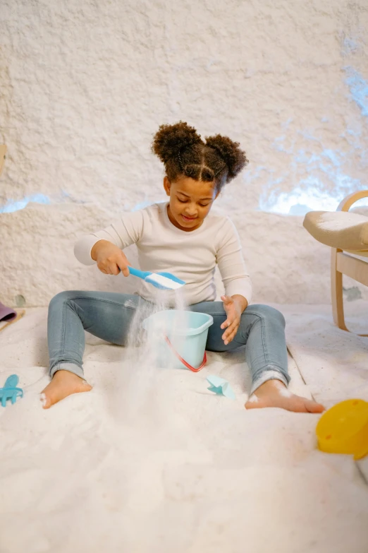 a little girl that is sitting in the snow, a child's drawing, pexels contest winner, scales with magic powder, playmates toys, water gushing from ceiling, sand banks