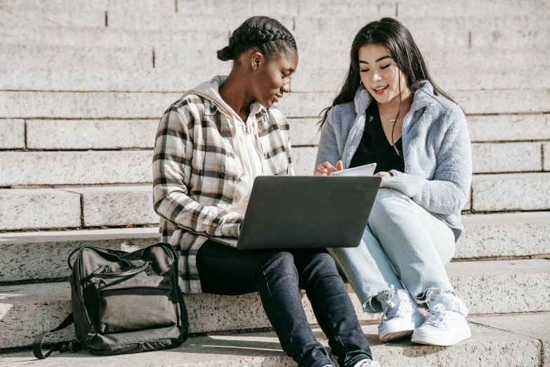 two people sitting on steps looking at a laptop, trending on pexels, academic art, young girls, varying ethnicities, on a notebook page, university