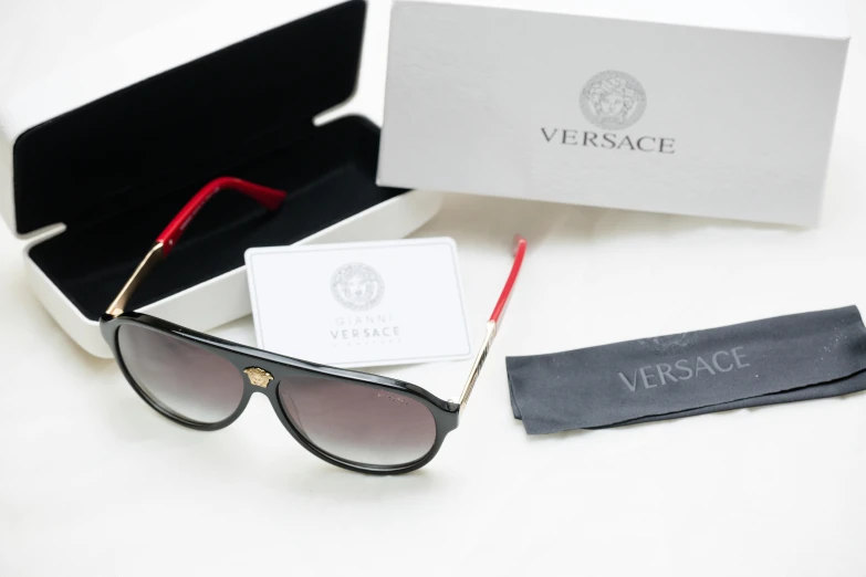 a pair of sunglasses sitting inside of a box, by Sebastian Vrancx, versace, ebay listing thumbnail, silver gold red details, product photo