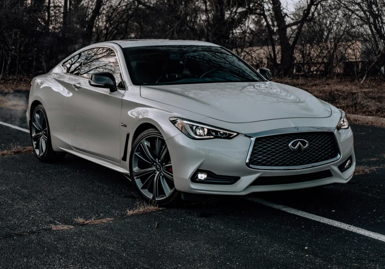 a white infiniti parked on the side of a road, by Matt Cavotta, pexels contest winner, 💋 💄 👠 👗, steel gray body, glazed, front flash