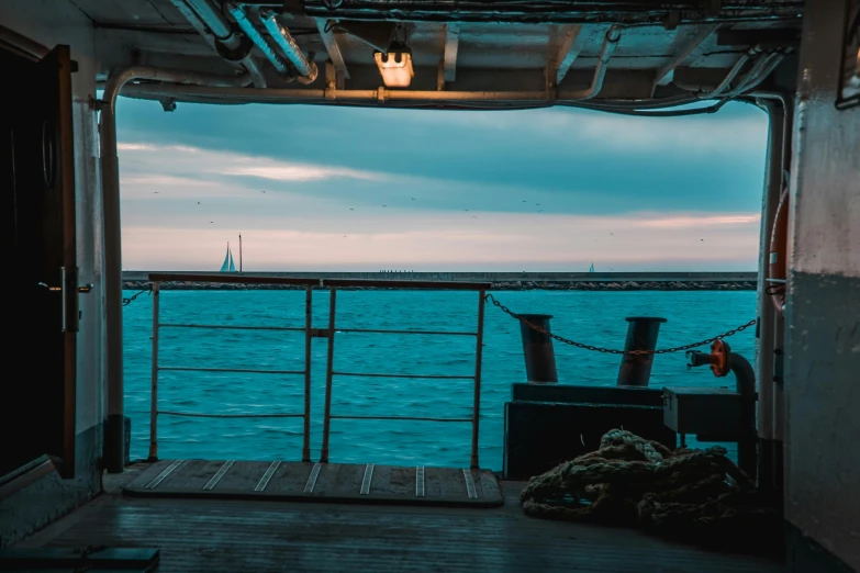 a view of the ocean from a boat, inspired by Elsa Bleda, pexels contest winner, standing on ship deck, dunkirk, evening time, teal sky